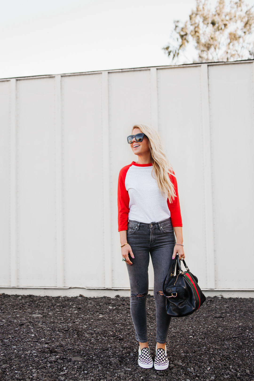 Lisa Allen of Salty Lashes wearing a baseball tee with AGOLDE jeans, Vans, and A Gucci Bag