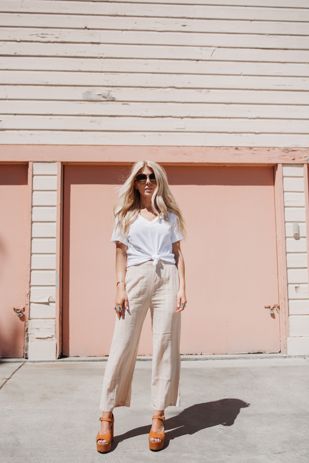 lisa allen of salty lashes wearing a white current elliott tee with UO cropped pants and Chloe Myrtle sunglasses in Encinitas CA