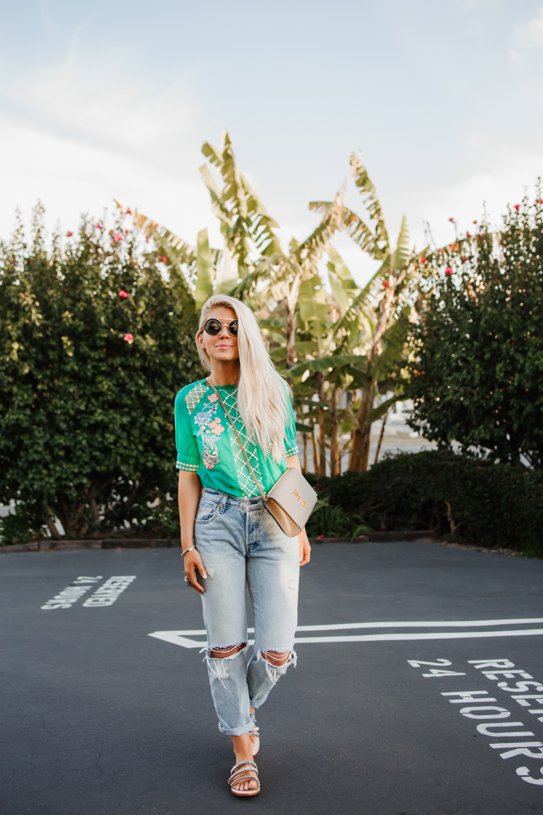Lisa allen of salty lashes wearing a green embroidered top from Anthropologie with levi's, ysl bag and jewel sandals, 