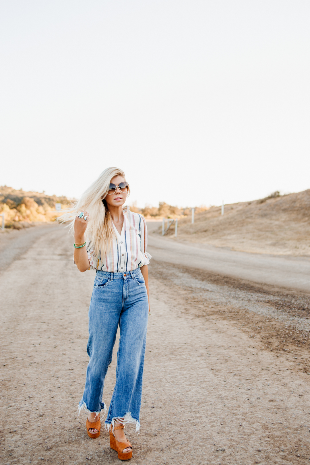 Lisa Allen of Salty Lashes wearing a stripe Anthropologie top with DL1961 jeans, Chloe sunglasses and Free People Platforms | New Arrivals for Summer 2018