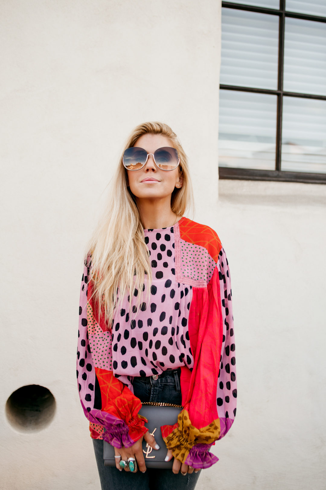 Lisa Allen of Salty Lashes wearing a Pink Anthropologie top with AGOLDE jeans, Anthropologie sandals, chloe sunglasses and YLS bag