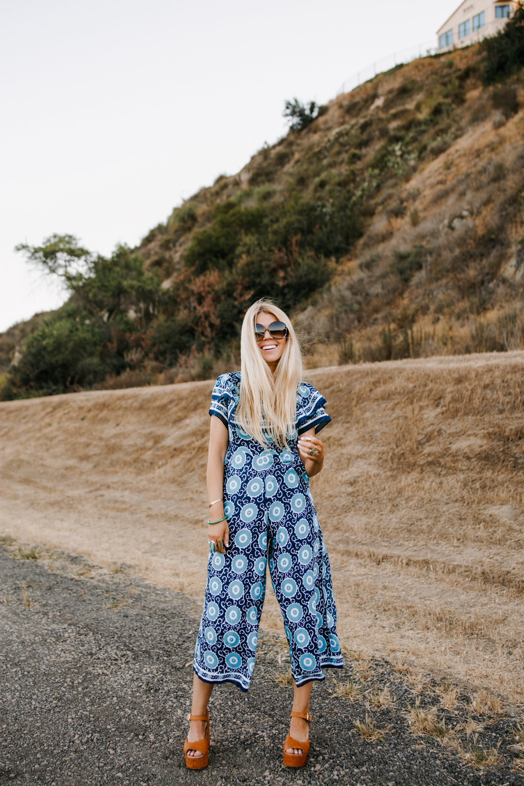 lisa allen of salty lashes wearing an Anthropologie patterned wide-leg jumpsuit