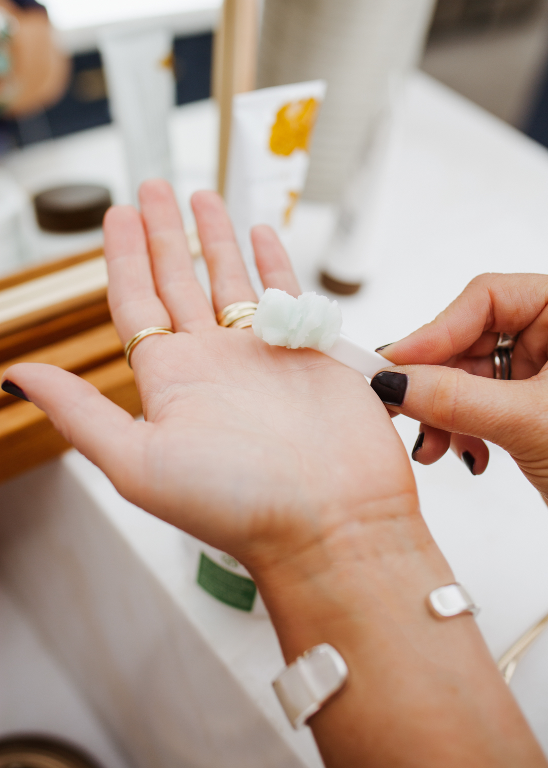 lisa allen of salty lashes putting a skincare product on her palm lisa allen of salty lashes putting a skincare product on her palm