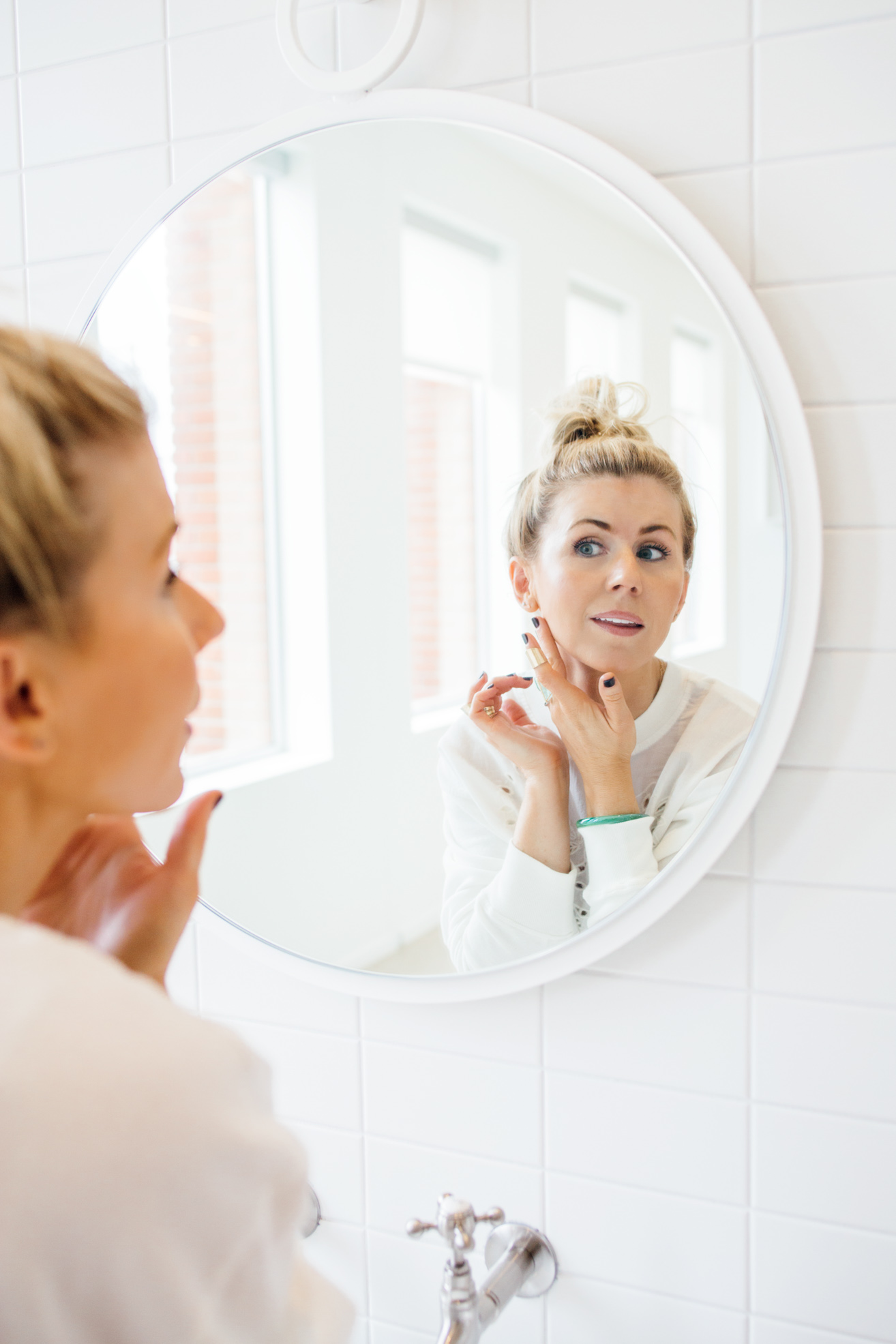 lisa allen of salty lashes applying skincare
