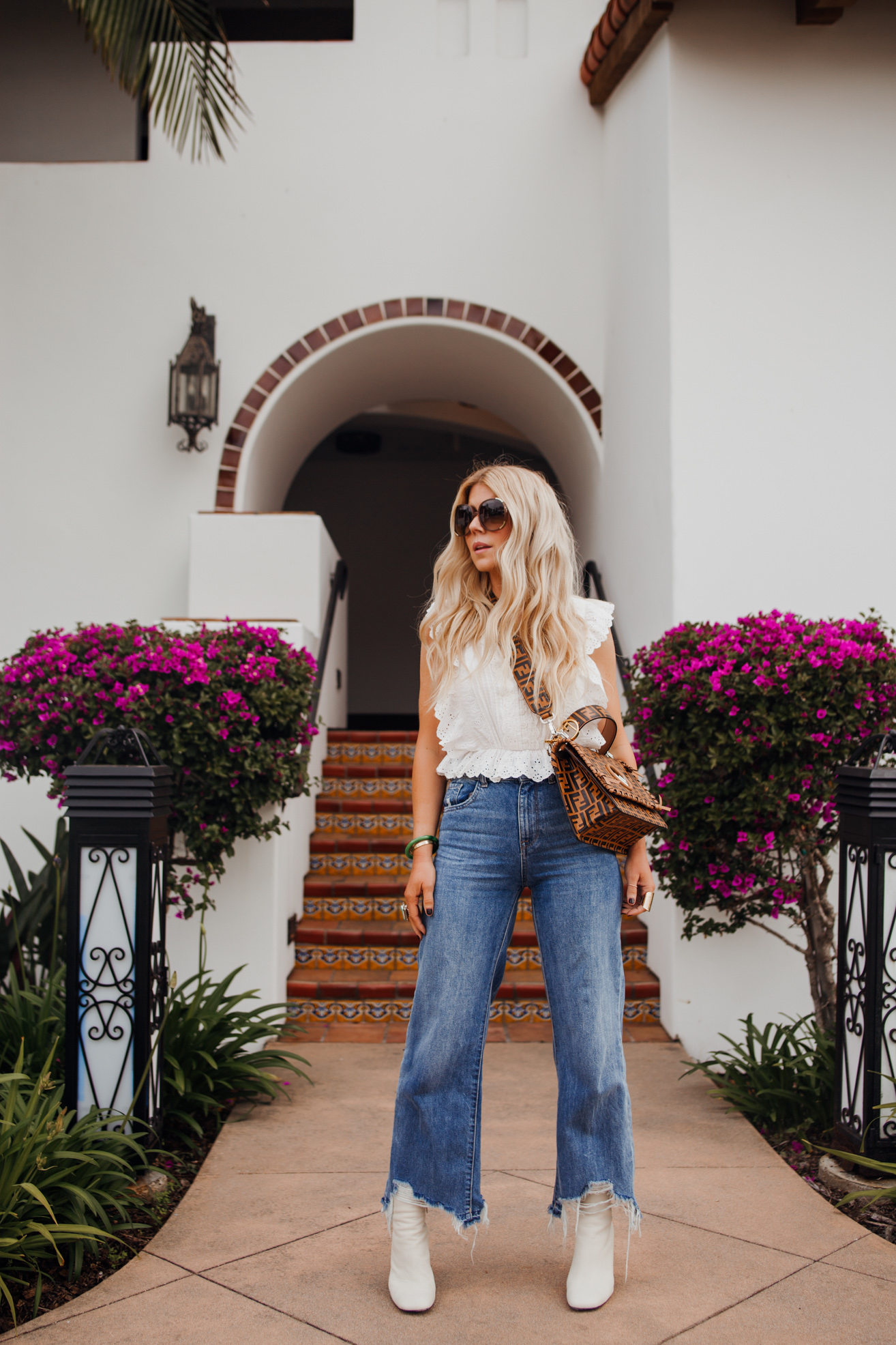 lisa allen wearing a white top with DL1961 jeans, white rag and bone booties and the fendi bag