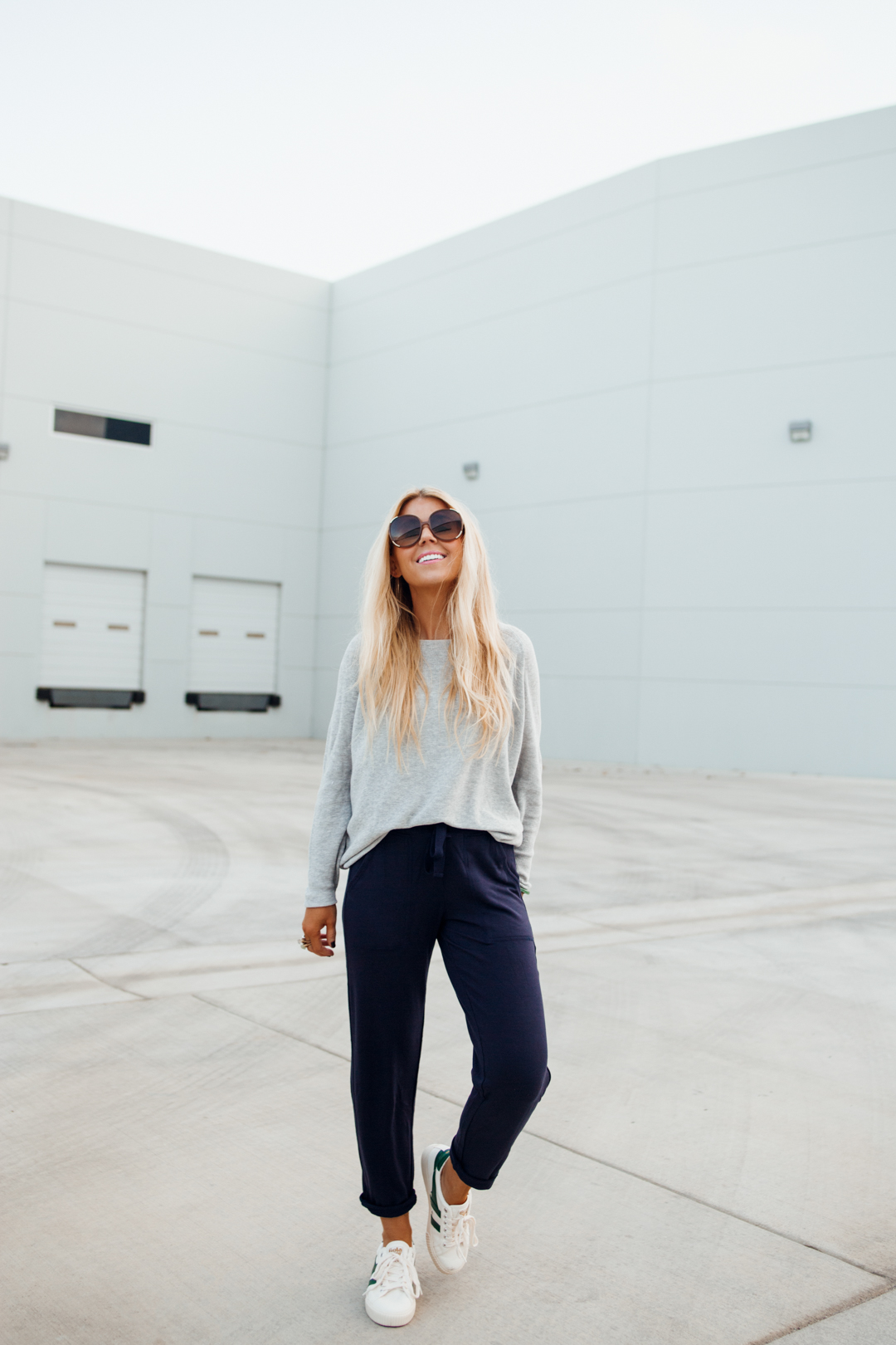 Lisa Allen styling soft sweaters with navy joggers and white Gola sneakers for a casual everyday look.