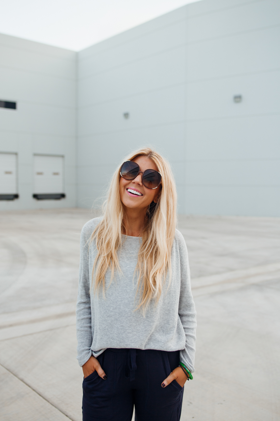 Lisa Allen of Salty Lashes wearing a Lou & Grey sweater, navy joggers and Gola sneakers.