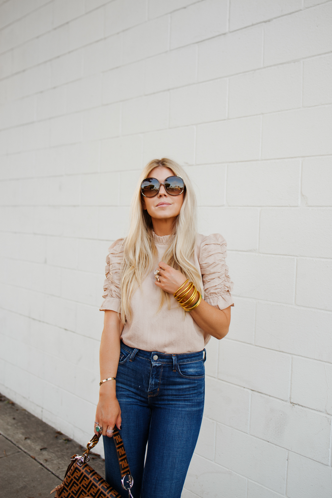 lisa allen of salty lashes sharing how to wear flare jeans with moon river, l'agence, a fendi kan bag and chloe sunglasses