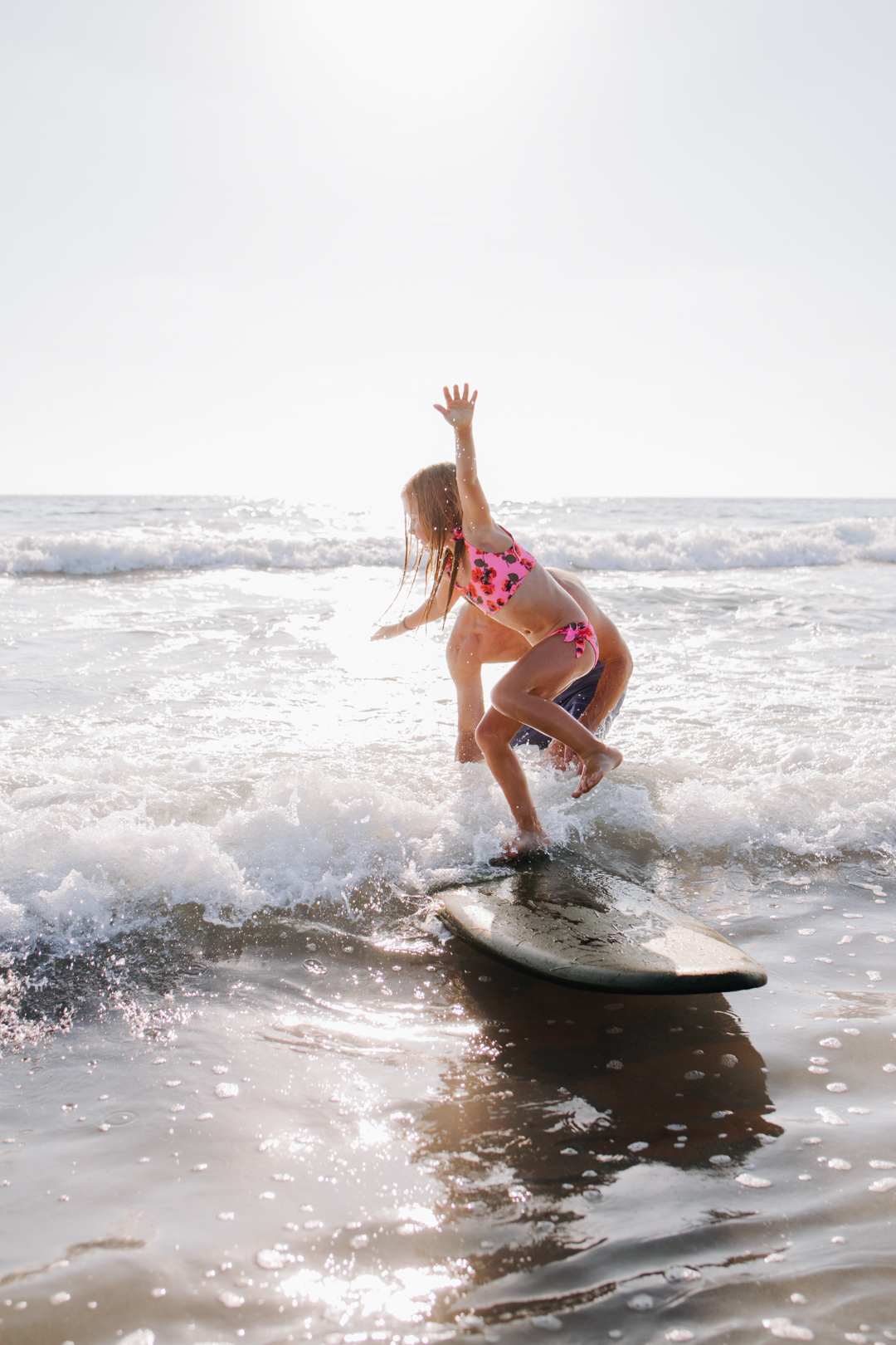 lisa allen of salty lashes with her husband jeff and daughters at the beach in encinitas CA showing Catch Surf, Yeti and Backcountry