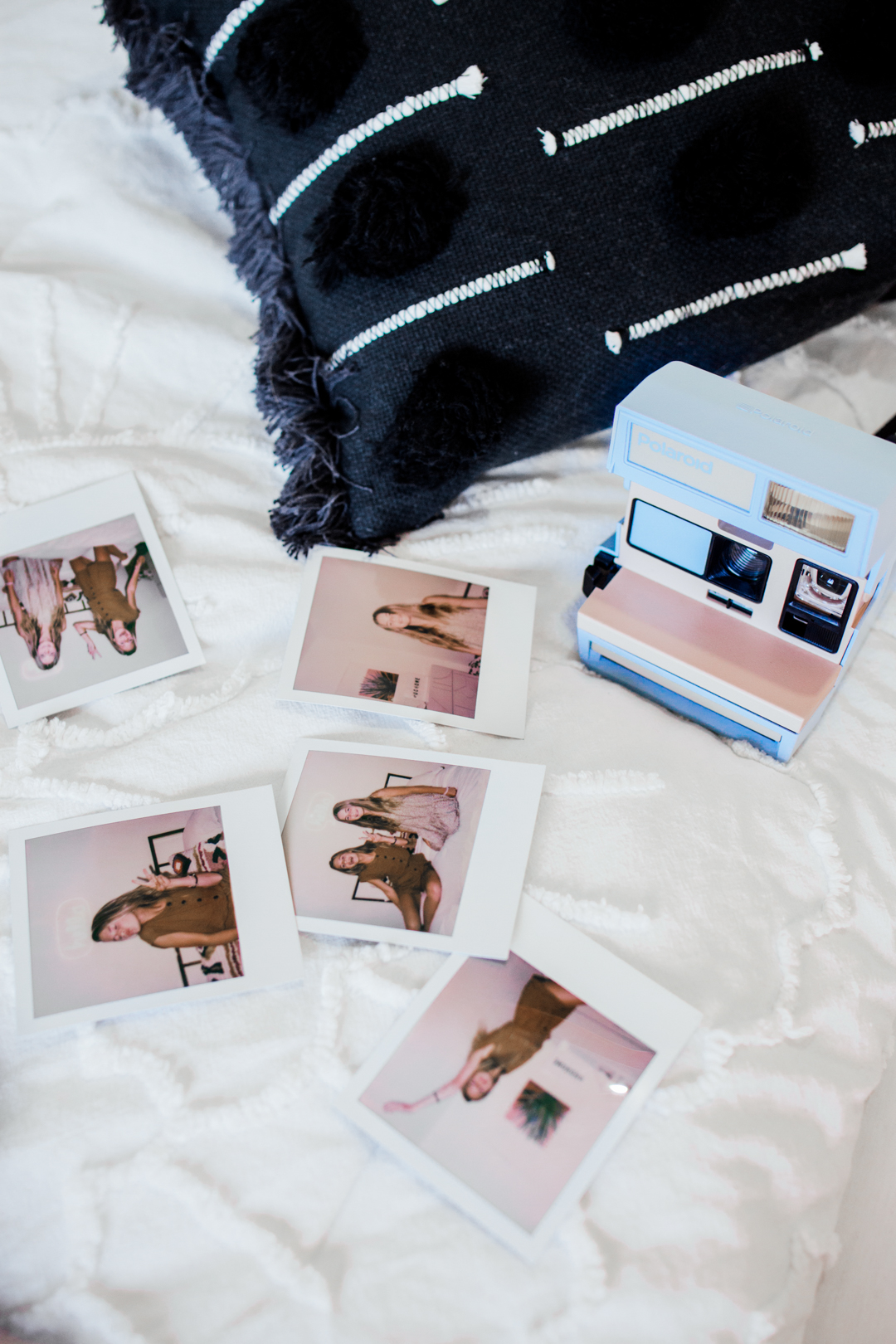 polaroid photos on the bed