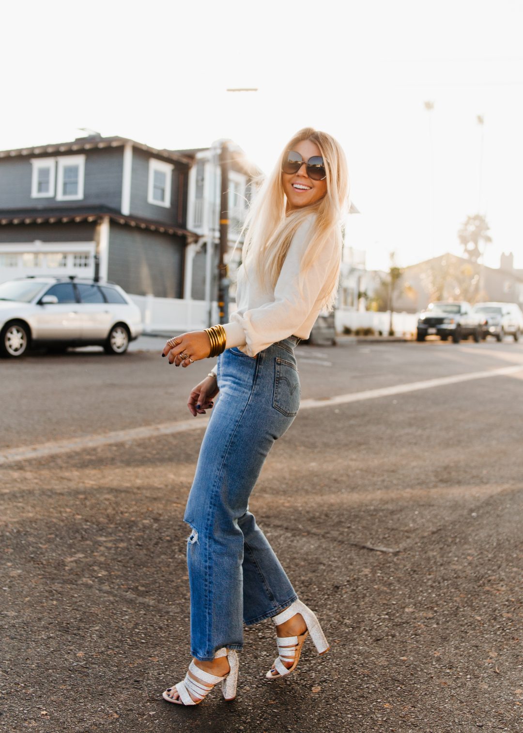 lisa allen of salty lashes wearing levi's ribcage jeans with glitter heels