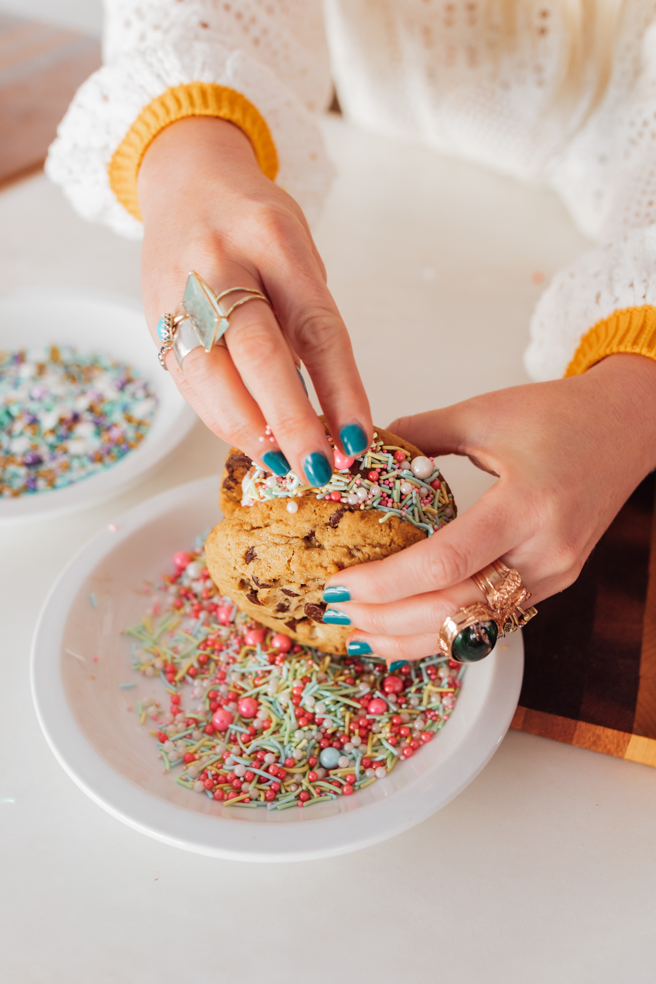 decorating ice cream sandwich with sprinkles