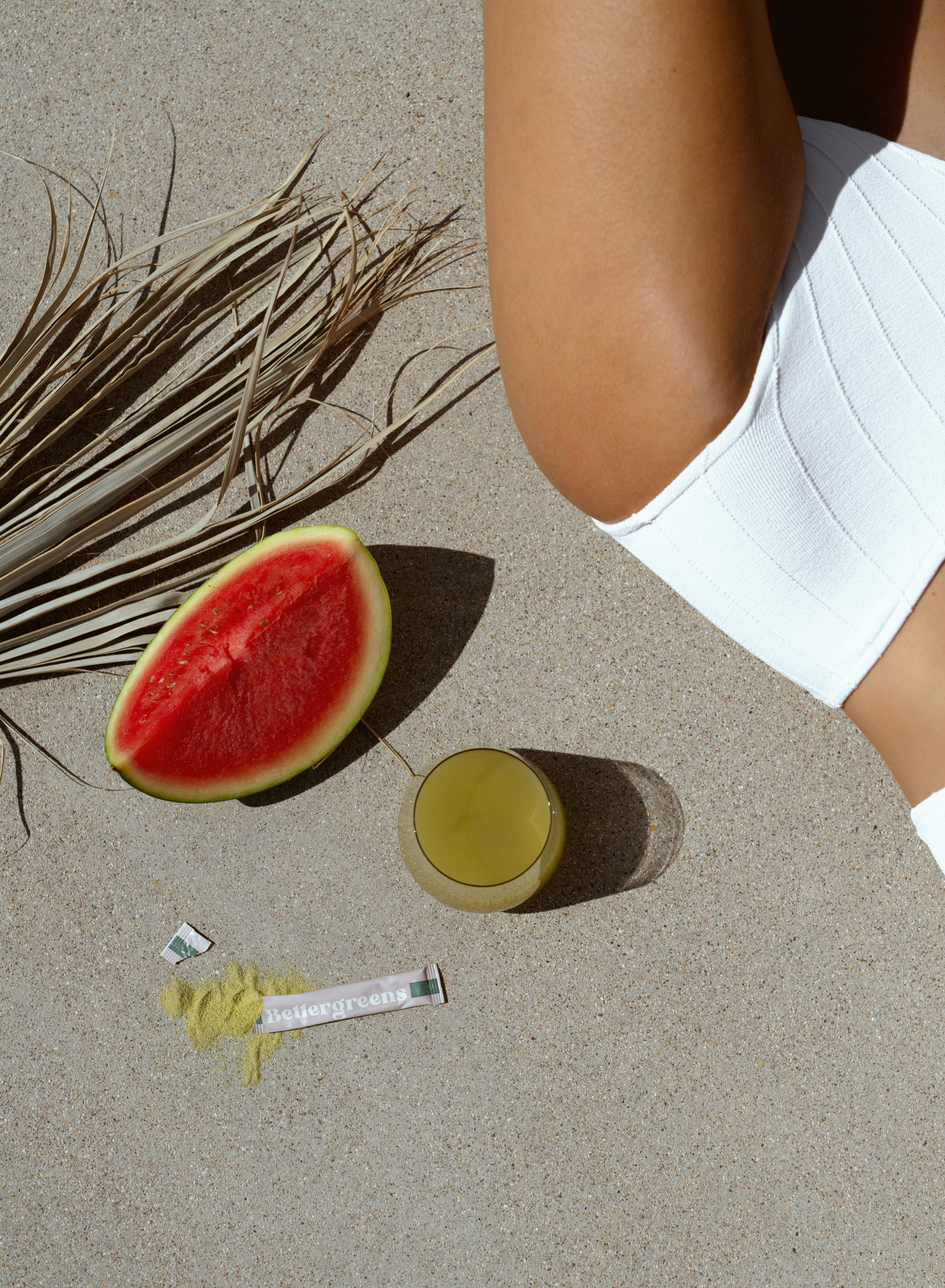 top view of fruit, drink, and a woman in a swimwear