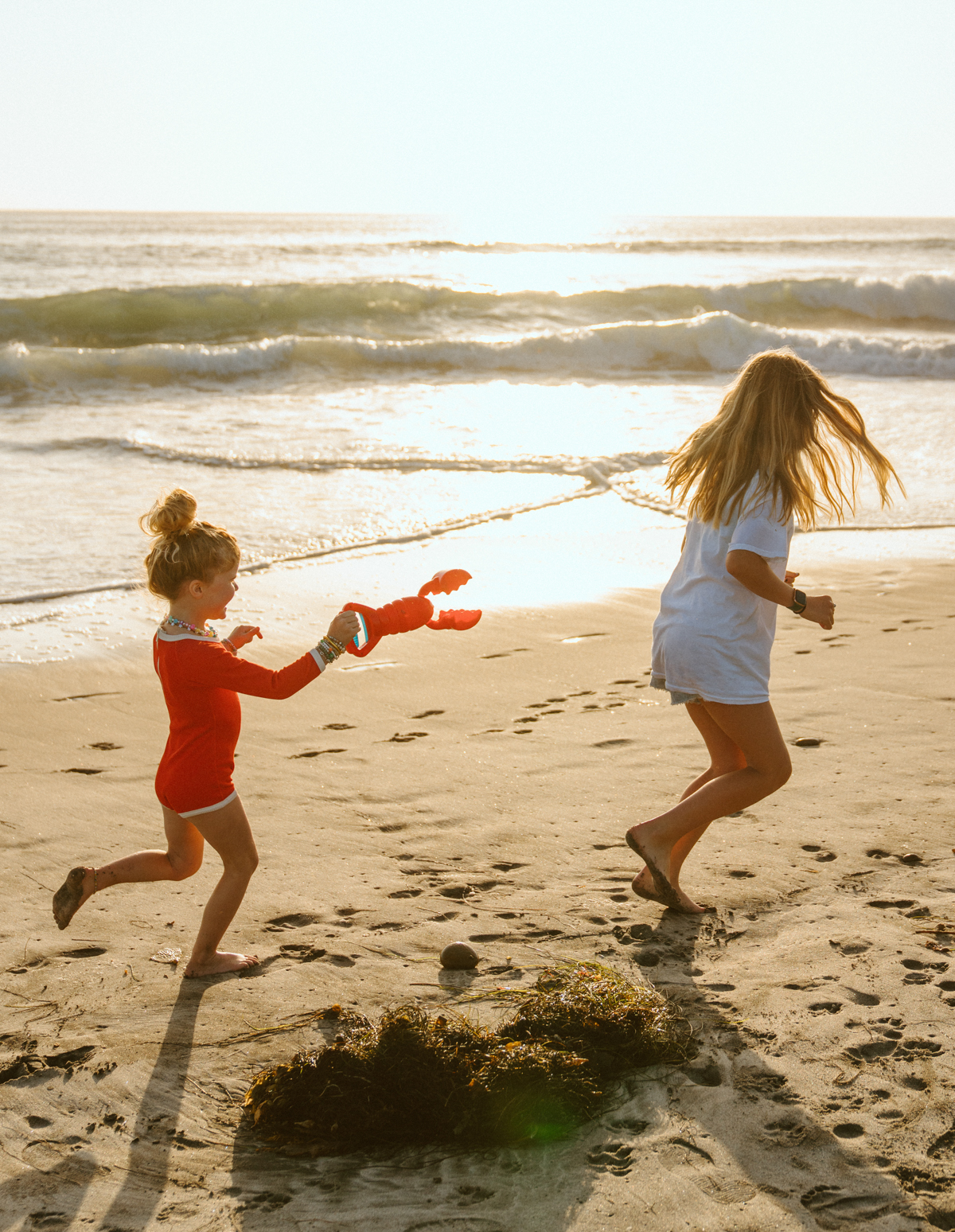 little girls running at the beach