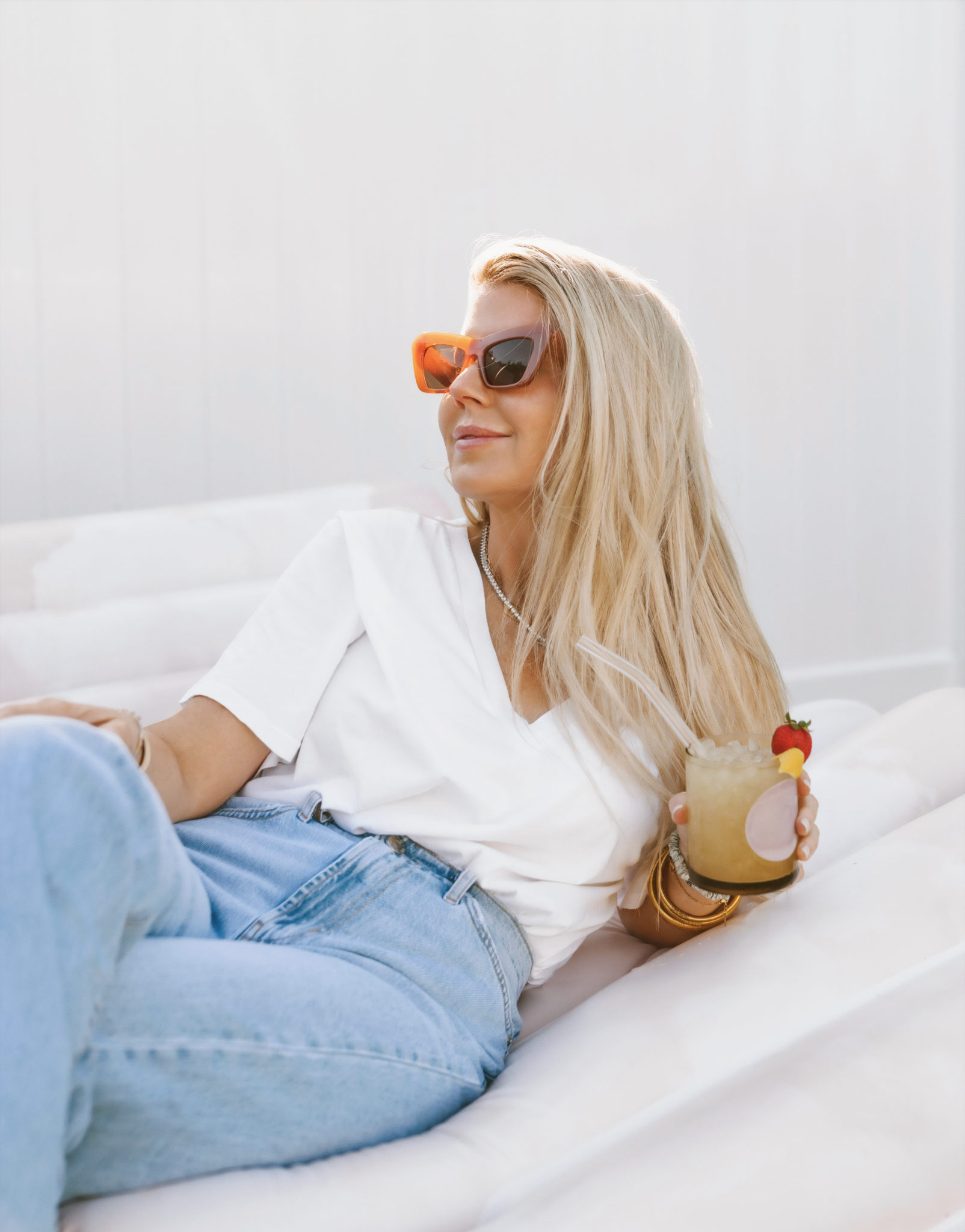 woman in white top and jeans and holding BetterDaysCo drink