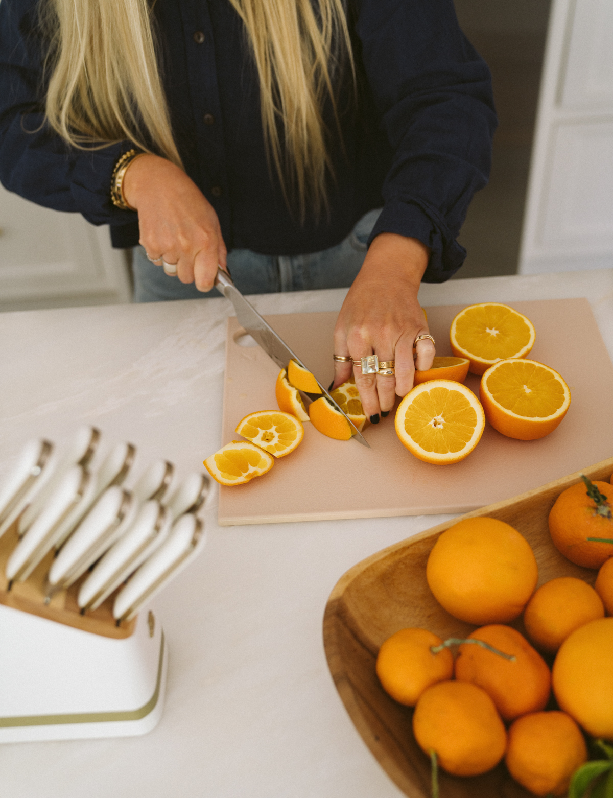 top view of woman slicing oranges
