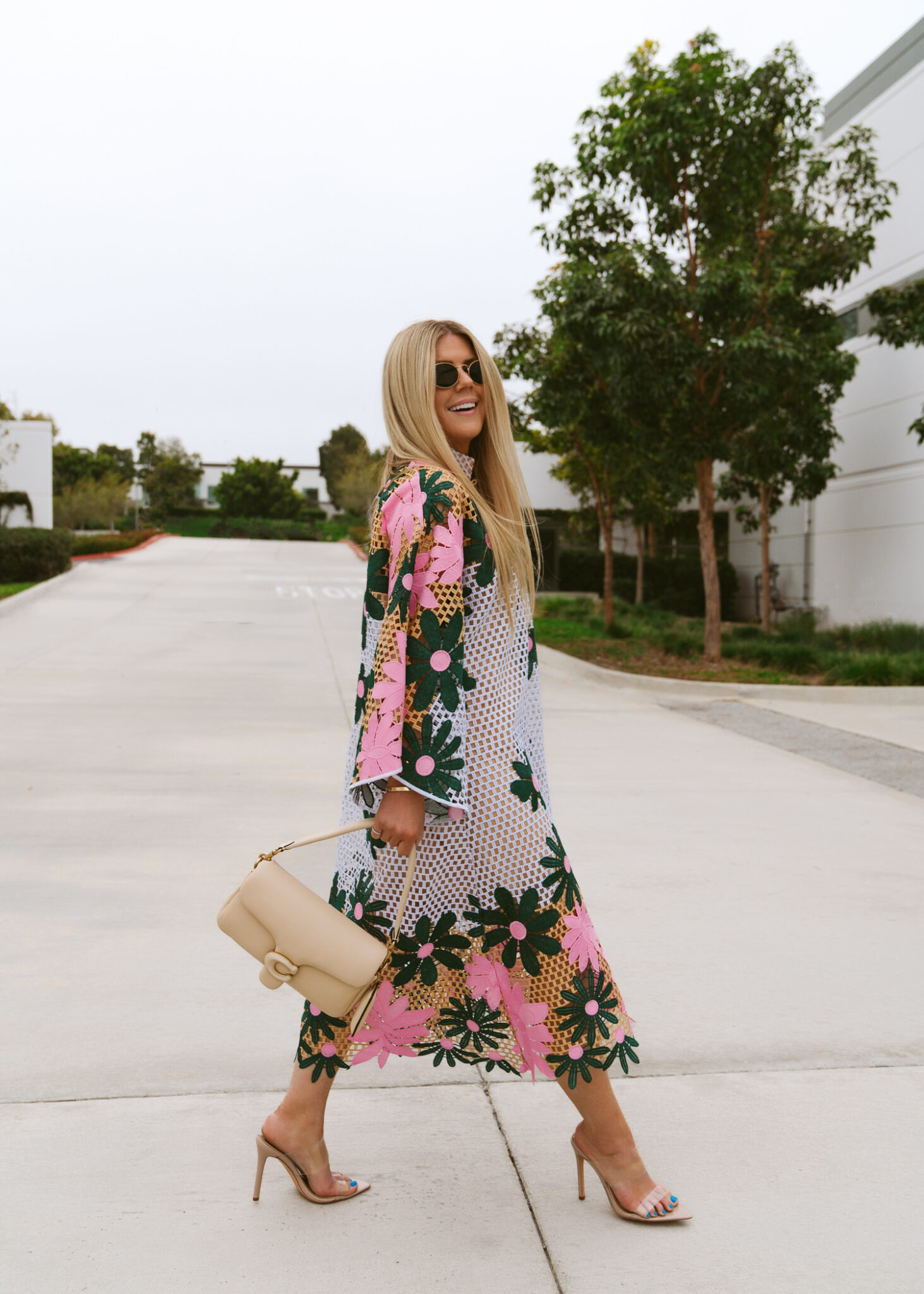 woman in printed dress and Coach Tabby Bag