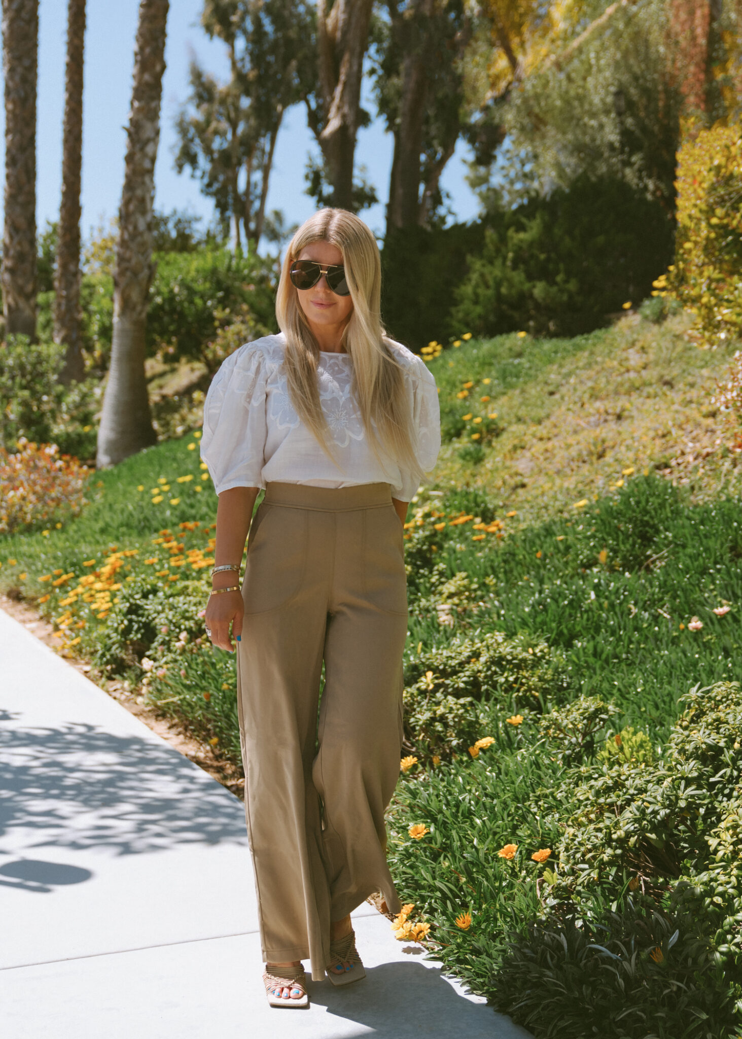 woman wearing white top , wide-legged pants, and sunglasses from With Saks OFF 5TH items 
