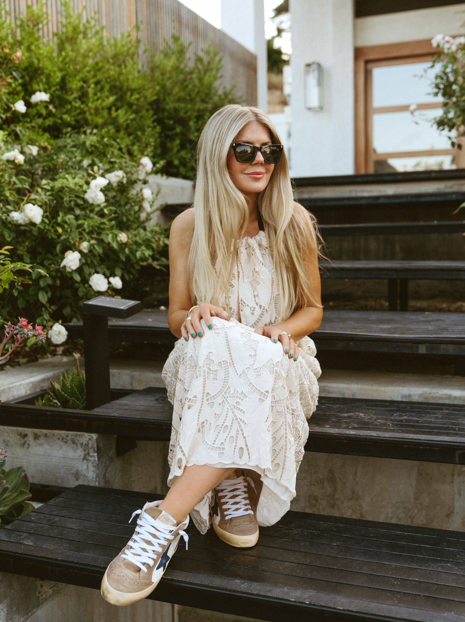 Lisa Allen Salty Lashes blogger sitting on the stairs and wearing a lace dress from the Nordstrom Summer Styles
