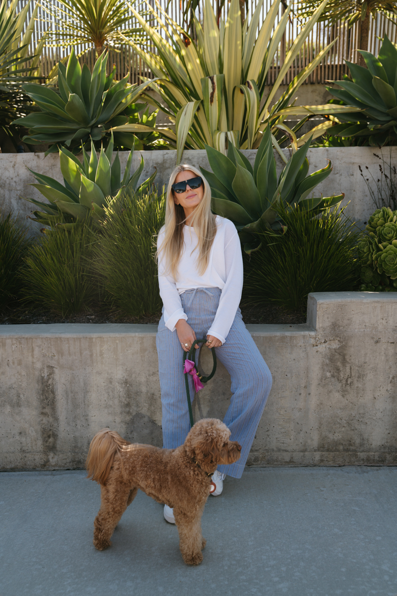 woman wearing white long sleeves  top and grey pants for spring at Urban Outfitters