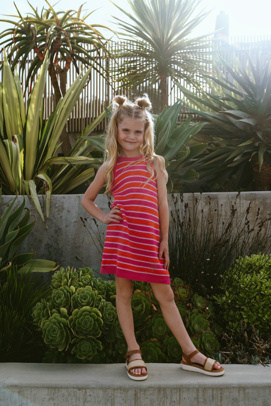 kid wearing striped dress