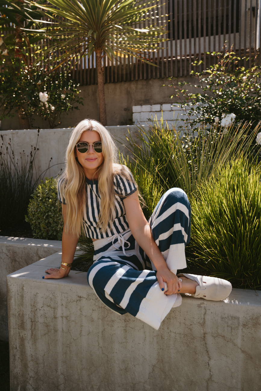 Salty Lashes Blogger Lisa Allen wearing a striped shirt and pants from Free People’s free-est Collection