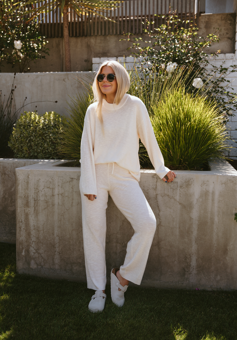 Salty Lashes Blogger Lisa Allen wearing loungewear from Free People’s free-est Collection and sunglasses