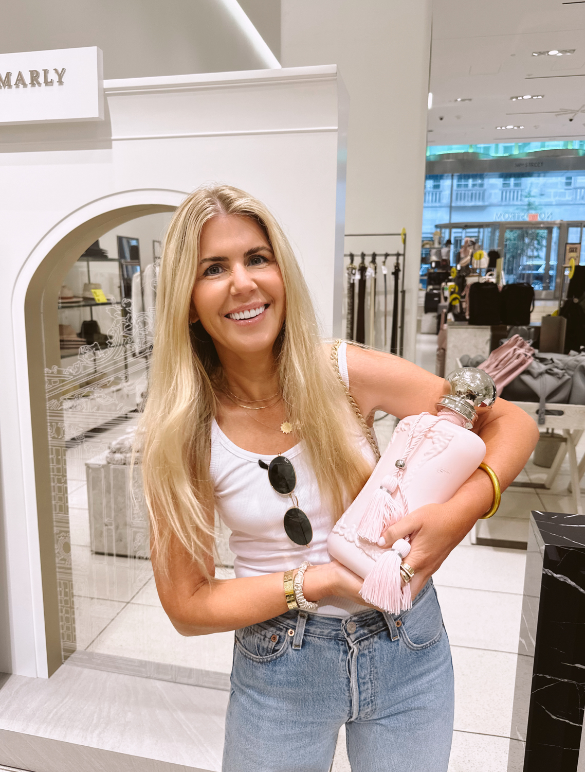 Salty Lashes Blogger Lisa Allen holding a product at the Nordstrom Anniversary Sale