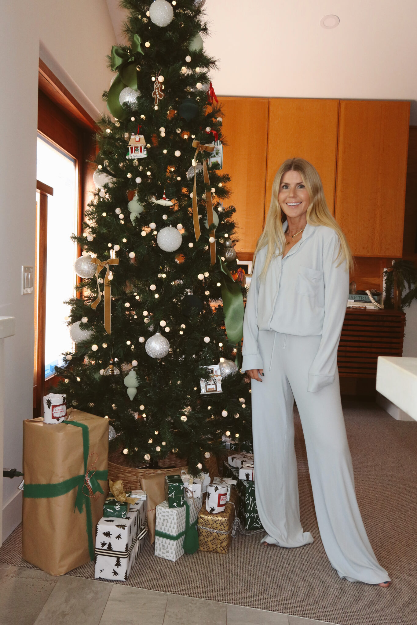  Salty Lashes Blogger Lisa Allen shares Gift Guide From Nordstrom while standing near the Christmas tree